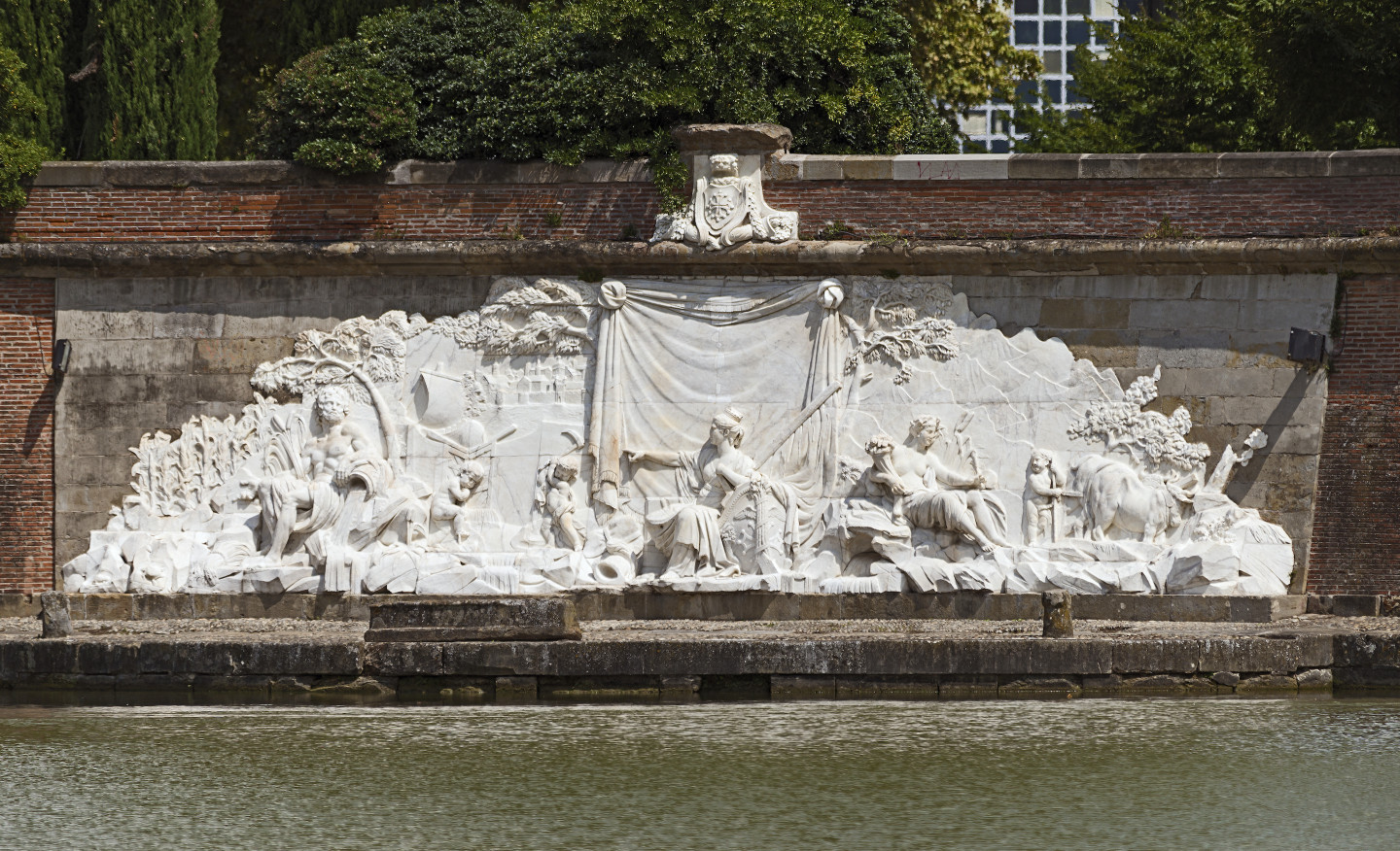 A Carrara marble bas-relief on the side of a canal. The allegorical sculpture depicts the story of the Canal's construction.